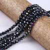A strand of dark blue faceted crystal glass spacer beads is draped over a cylindrical brown material.