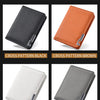 A display of four cross-patterned leather wallets in black, brown, white, and gray.