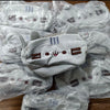 A pile of cute cat plush pencil cases with zipper closures in light gray fabric, packaged in clear plastic bags.