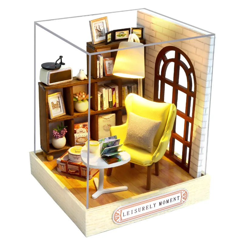 A wooden miniature dollhouse kit featuring a yellow armchair, shelves, and a wooden arched window with an illuminated lamp.