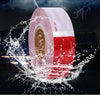 Roll of waterproof multi-location reflective safety tape being splashed by water.