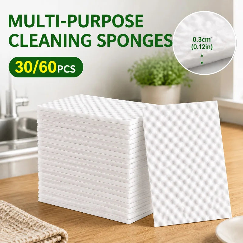 A stack of white multi-purpose cleaning sponges is shown on a wooden surface.