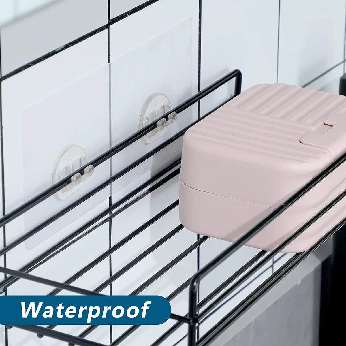 A pink plastic container is hanging on a black wire rack using no-drill adhesive hooks.