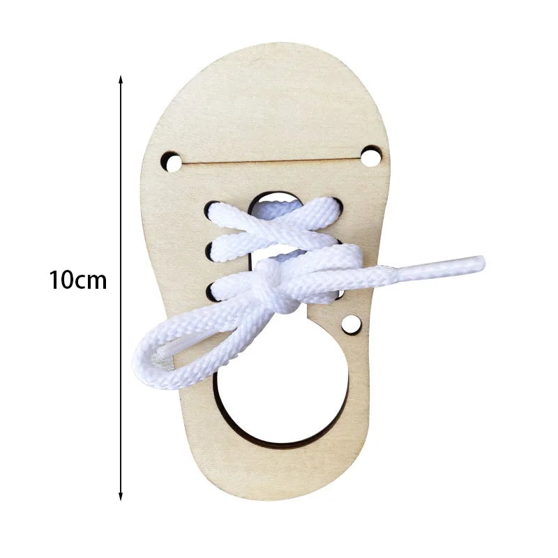 A wooden Montessori busy board component showing a piece of light wood with holes and a white cord tied in a knot.