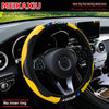 Yellow and black carbon fiber steering wheel cover for a car, shown inside the vehicle