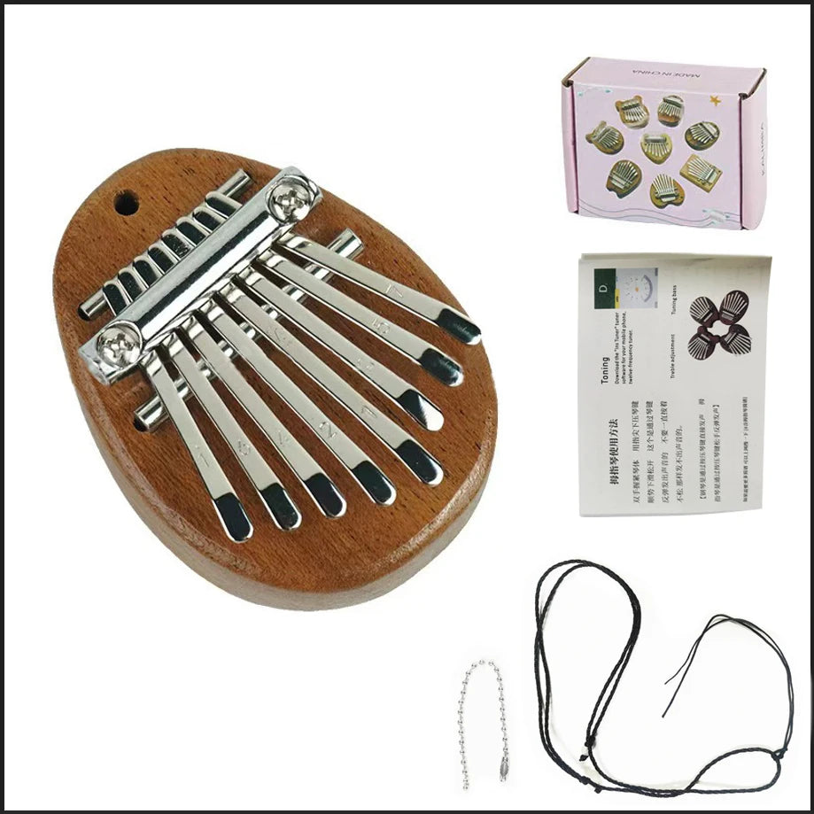 A wooden mini 8-key kalimba thumb piano with metal keys and a carrying box shown next to its cord.