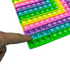 A hand is holding a colorful push bubble math game with numbered bubbles for addition and multiplication learning.