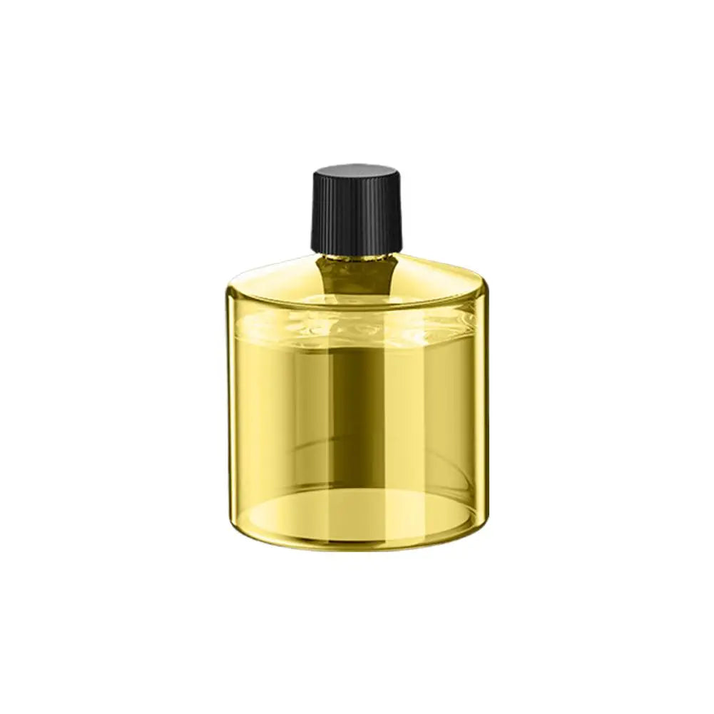 A clear glass bottle with a black cap, likely an aroma diffuser.