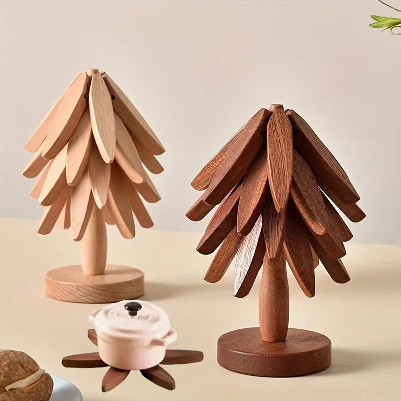 A set of wooden tree-shaped heat-resistant trivets displayed on a light surface.