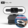 A black 2K Full HD webcam with a built-in fill light and microphone mounted on a stand.
