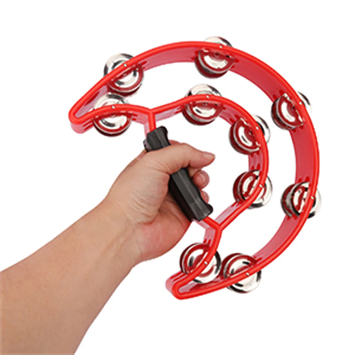 A hand is holding a red half-moon tambourine with double rows of metal jingles.