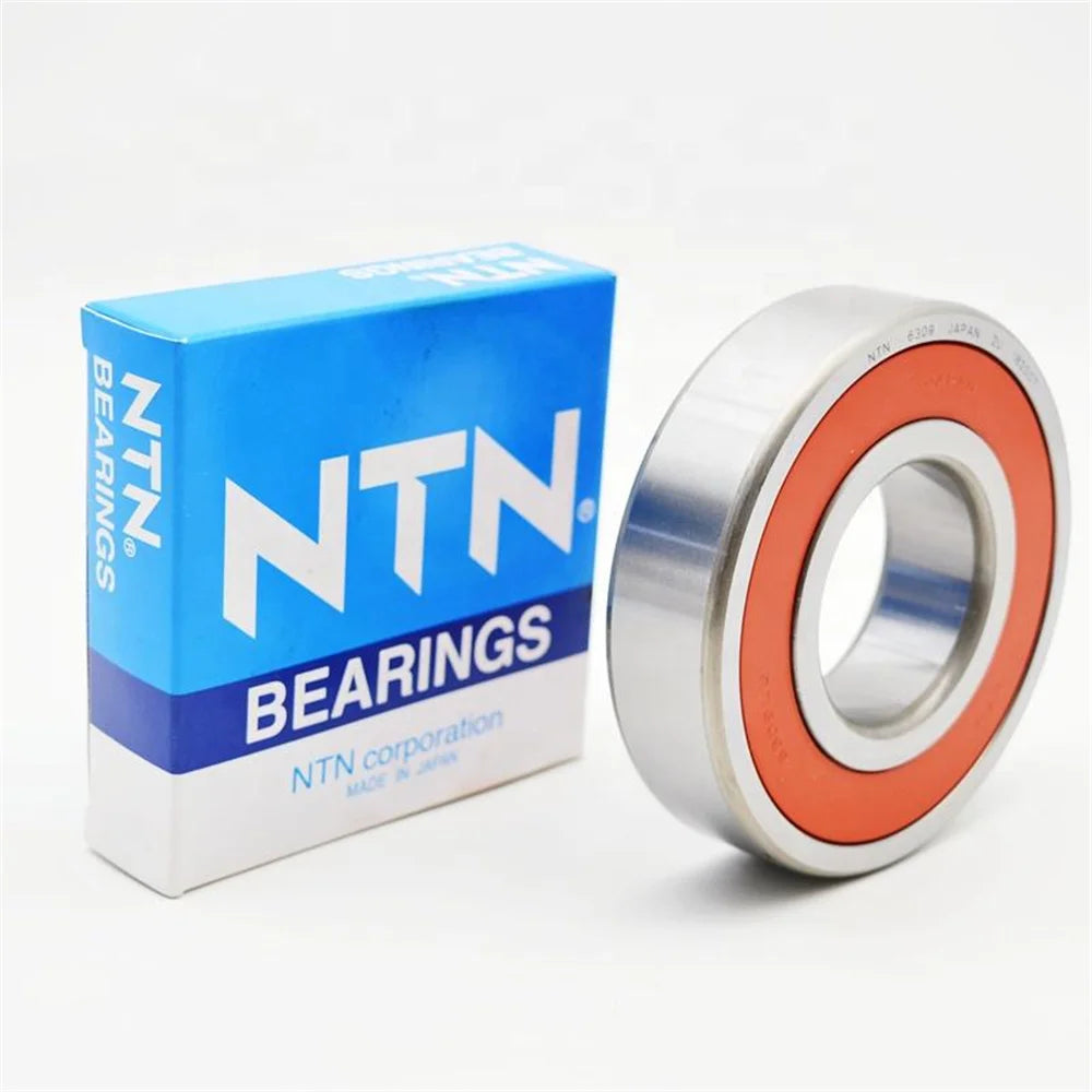 A blue box of NTN bearings next to a silver deep groove ball bearing.