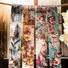 A collection of vintage botanical washi tape strips featuring floral and natural elements tied together on twine.