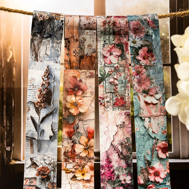 A collection of vintage botanical washi tape strips featuring floral and natural elements tied together on twine.