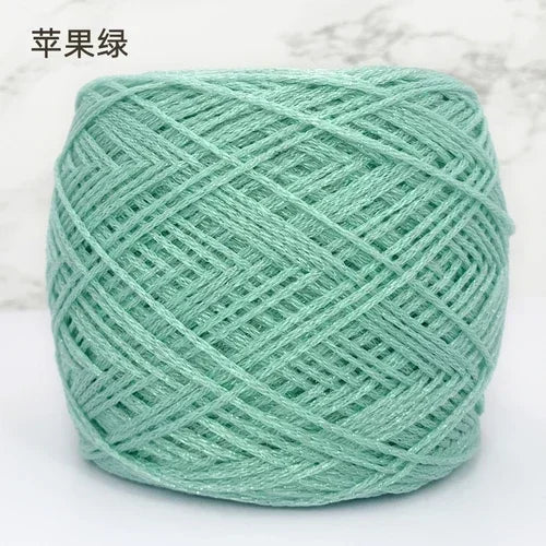 A ball of light mint green metallic silk crochet yarn for knitting and macrame.