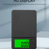 A black pocket digital scale with a bright green backlit display showing 0.00 and MP and power buttons.