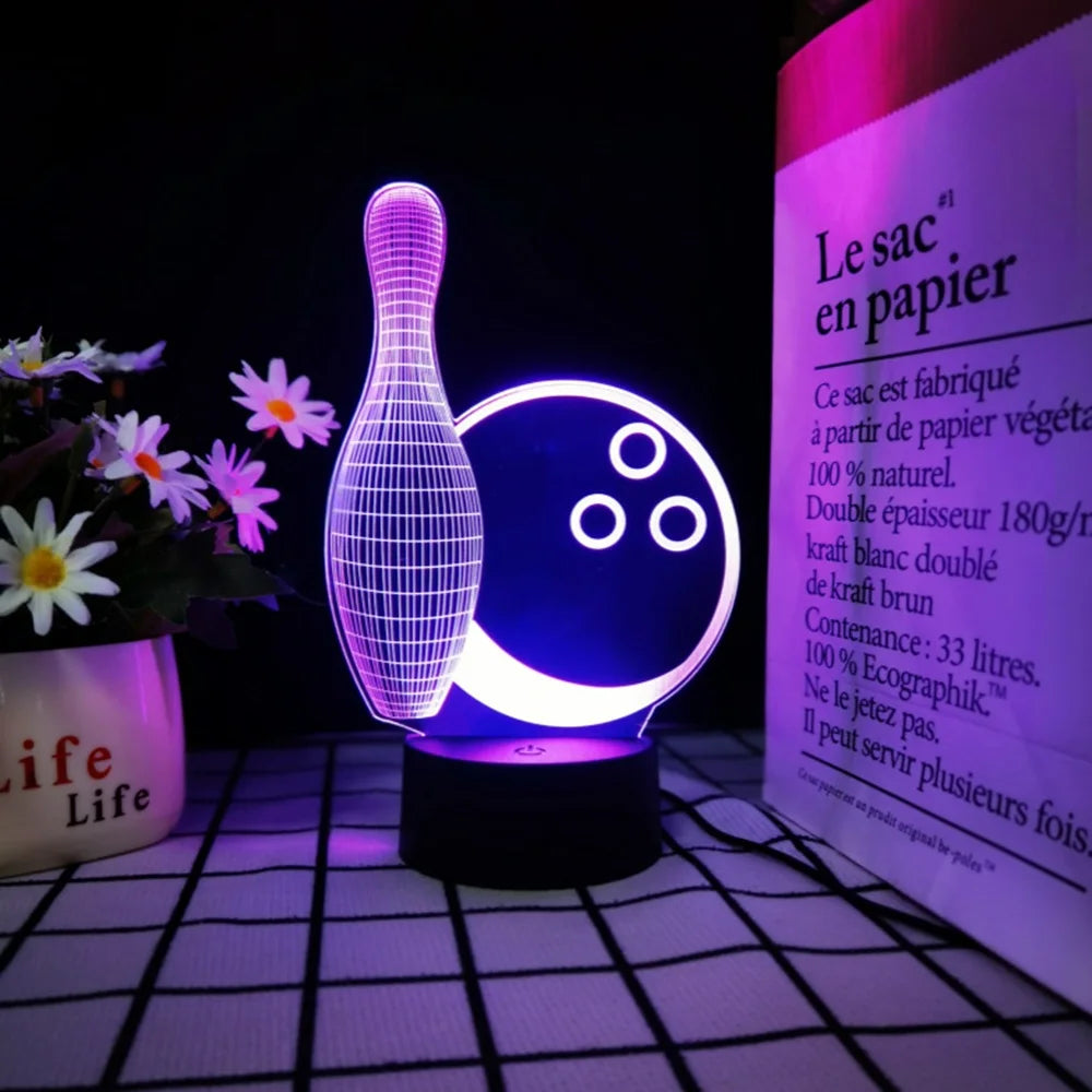 A glowing glass-shaped night light illuminates a piece of paper, demonstrating a 3D illusion effect.