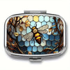 A portable metal pill organizer and jewelry case featuring a detailed bee design on a hexagonal background.