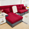 A deep red sectional sofa with gray fabric and white accents sits on a light wood floor.