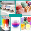 A collection of colorful wax candles and candle making supplies including dyed soy, beeswax, and soap making materials.