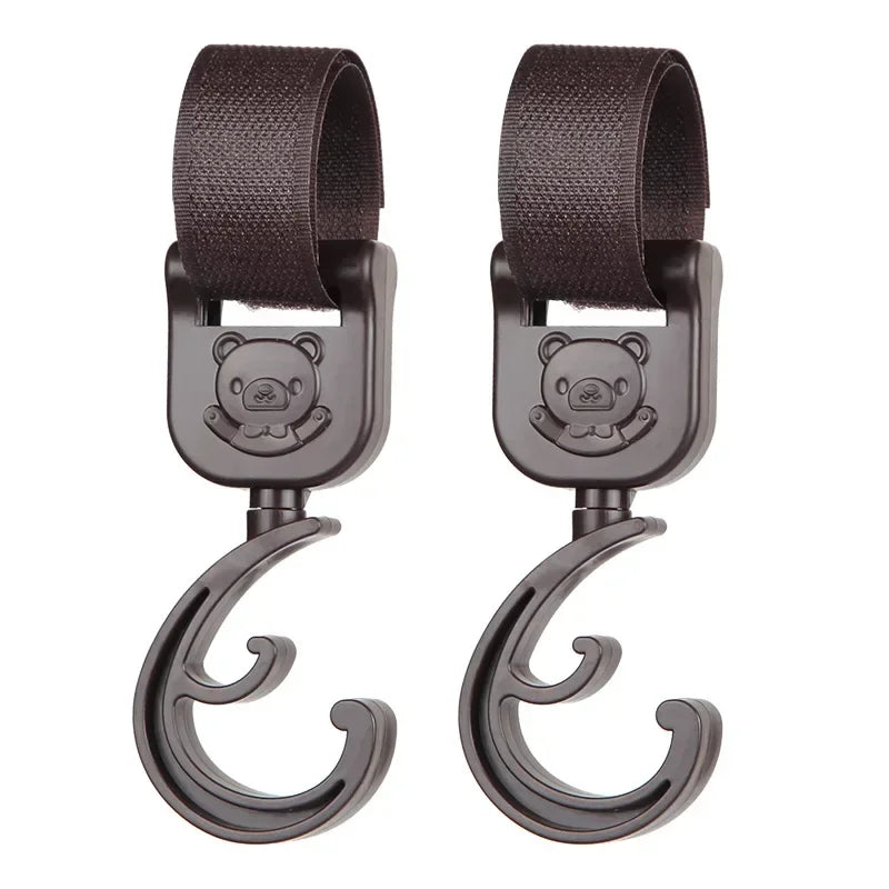 A pair of dark brown rotating stroller hooks designed for hanging bags and essentials.