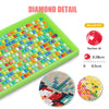 A green tray filled with colorful seed beads for a diamond painting kit showing various bead colors and a magnified view of t