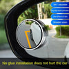 A 360 degree adjustable blind spot mirror installed on a car window, showing a view of the road.