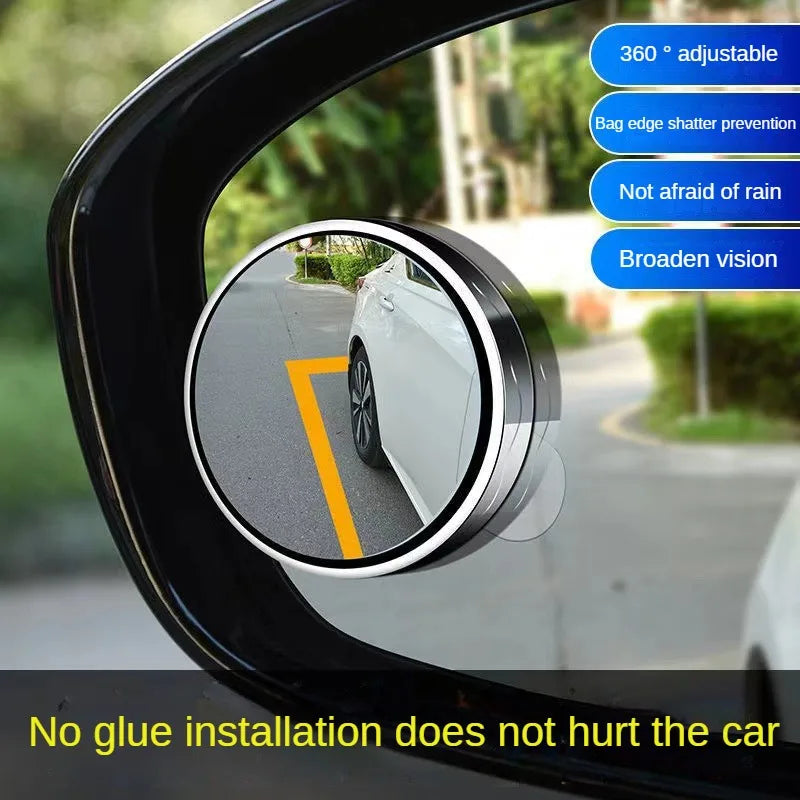 A 360 degree adjustable blind spot mirror installed on a car window, showing a view of the road.