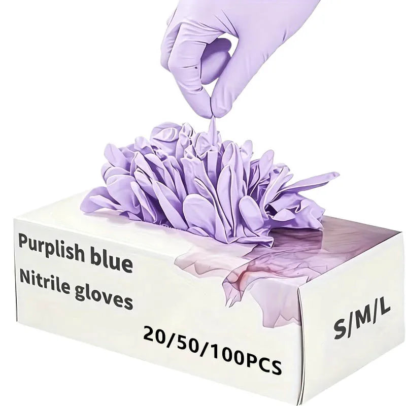 A hand in a purple nitrile glove is placing a cluster of light purple disposable nitrile gloves into a box.