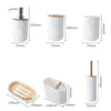 A set of bamboo bathroom organizers including a soap dispenser, toothbrush holder, and storage cup.