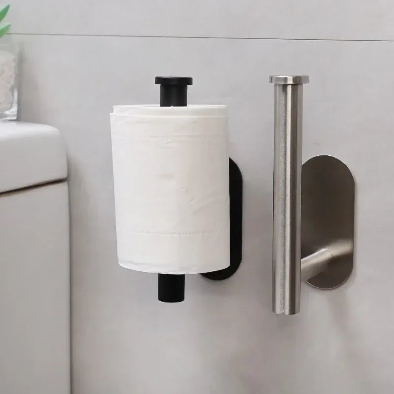 A stainless steel self-adhesive toilet paper holder mounted on a white wall.