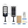 A black solar wall light with a motion sensor and remote control, shown alongside its components.