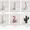 A collection of handcrafted ceramic elephant and rabbit jewelry holders and desk ornaments in various sizes and colors.