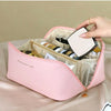 A pink leather travel makeup organizer bag is shown open, displaying various cosmetic items and a compact mirror.