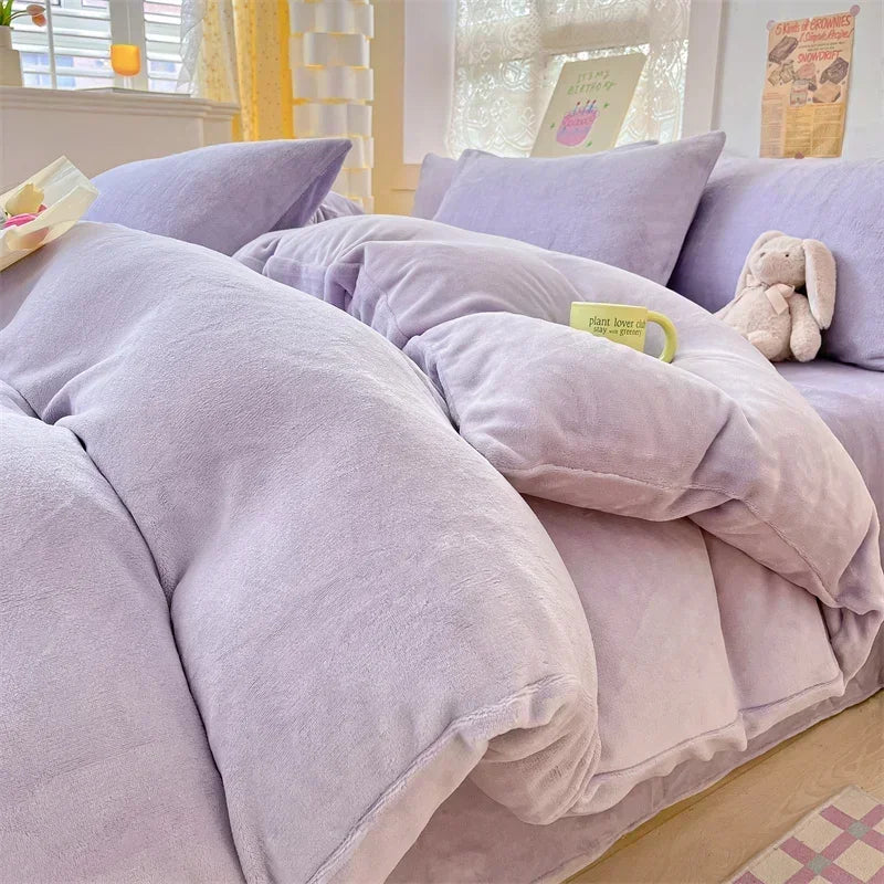 A purple cozy milk velvet bedding set featuring a duvet cover and pillows on a bed.