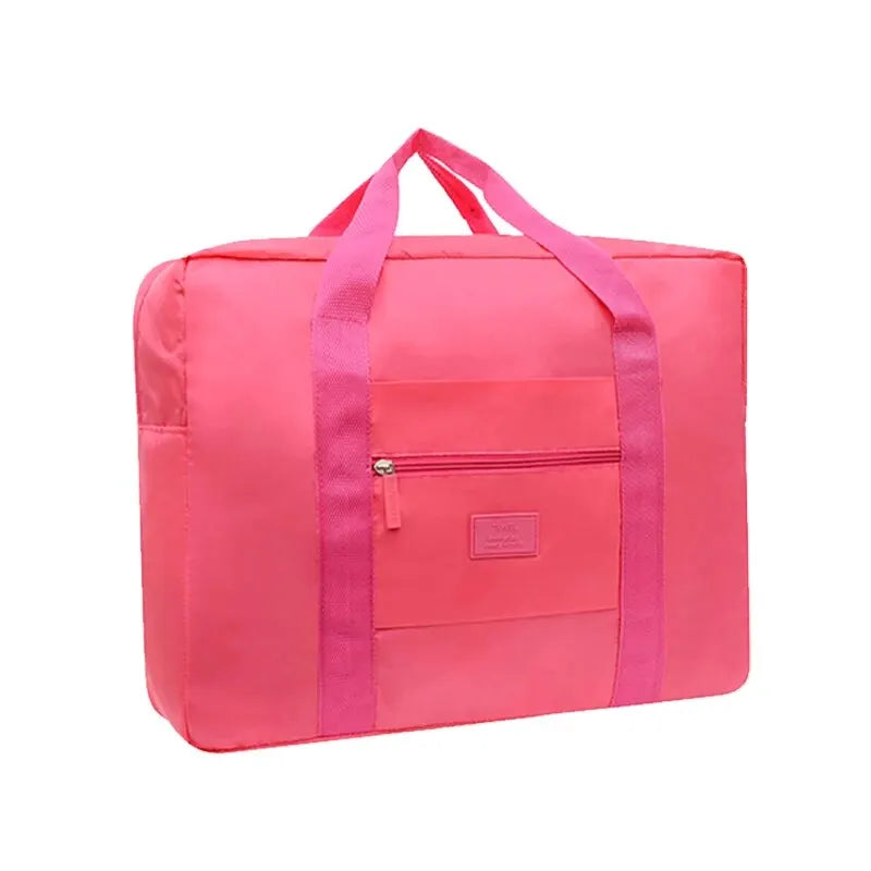 Helle pinke faltbare Reise-Duffeltasche mit rosa Trägern und verschließbarem Fach.