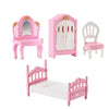 A pink dollhouse furniture set featuring a vanity, a cabinet, and a bed for miniature play.