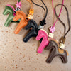 A collection of leather pony charms in various colors including green, orange, black, pink, and brown.