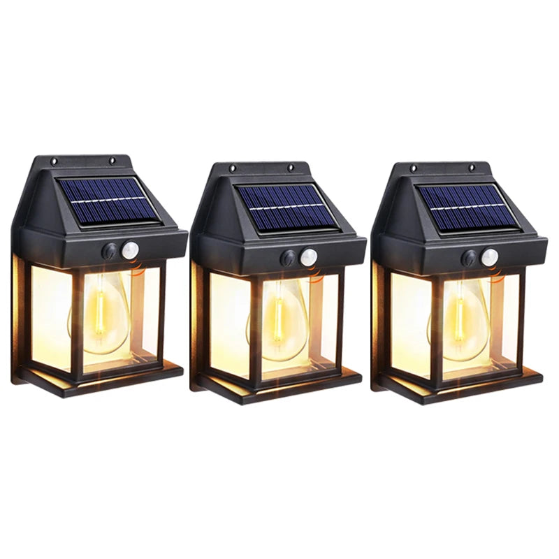 A black solar-powered wall light fixture with a glass bulb and a solar panel on top.