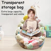 A boy is sitting inside a large, transparent storage bag filled with soft plush toys.