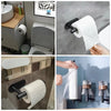 A set of five stainless steel bathroom accessories, including a toilet paper holder and dispenser, mounted with adhesive stri