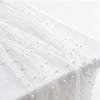 White tulle table runner adorned with small pink faux pearls.