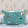 A teal cartoon pillow featuring various animal and nature motifs like a fox, leaves, and berries.