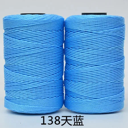 Two spools of bright blue 3-ply polyester knitting yarn for crochet and hand crafts