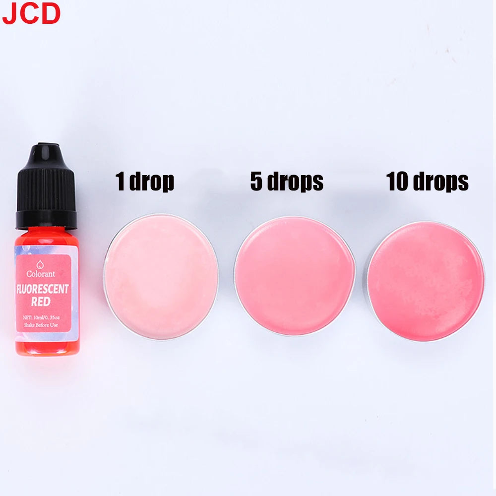 A set of fluorescent red liquid candle dye in dropper bottles showing 1, 5, and 10 drops of the pink color.