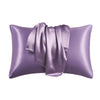 A purple silky smooth satin pillowcase with a gathered fabric detail.