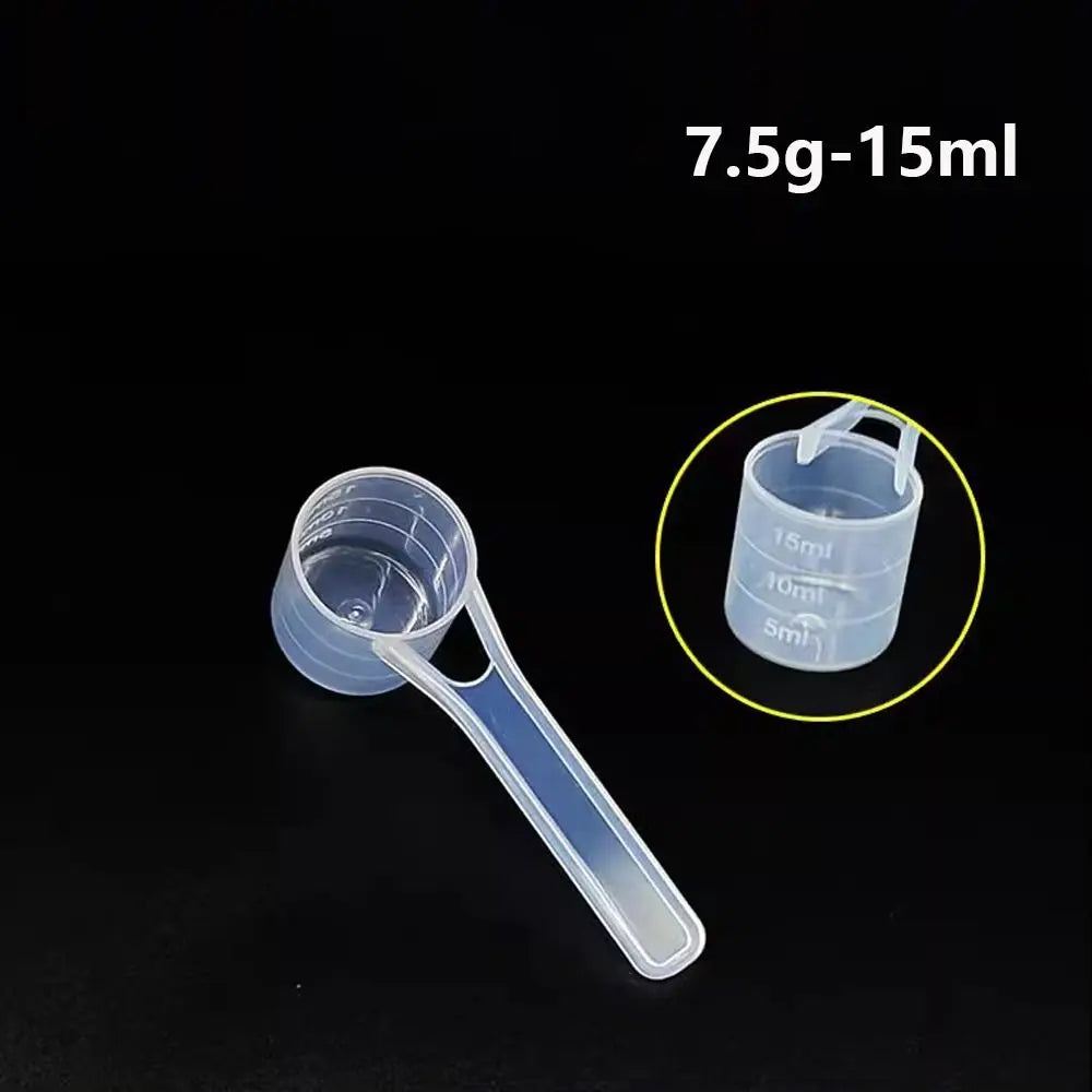 Clear plastic measuring cup with a long spout showing volume markings for 5ml to 15ml