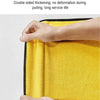 A hand is holding a bright yellow, thick, double-sided cleaning towel.