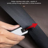 A hand is using a hidden stainless steel cutter to cut through a seat belt in a fabric, demonstrating an emergency tool.
