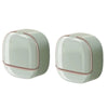 A pair of light green waterproof hanging soap holders with drainage features.